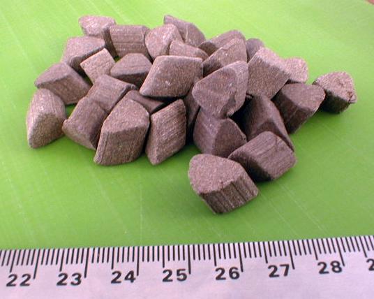 An abrasive mass finishing media used for "roughing" or cutting in mass finishing machine finishing operations.